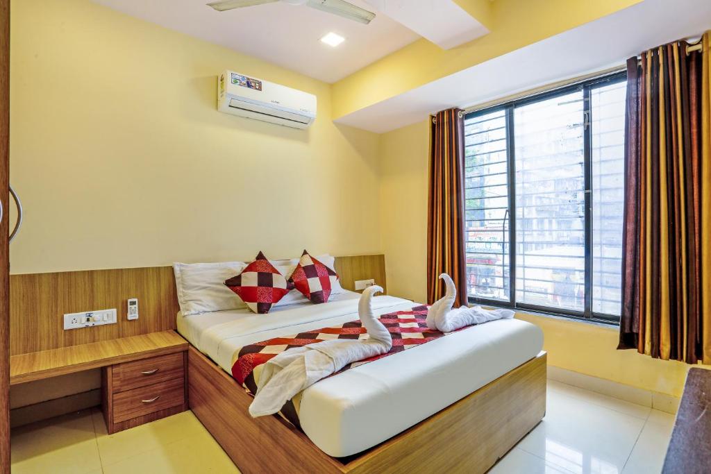 a bedroom with a bed with swans on it at BKC Dormitory Bandra East in Mumbai