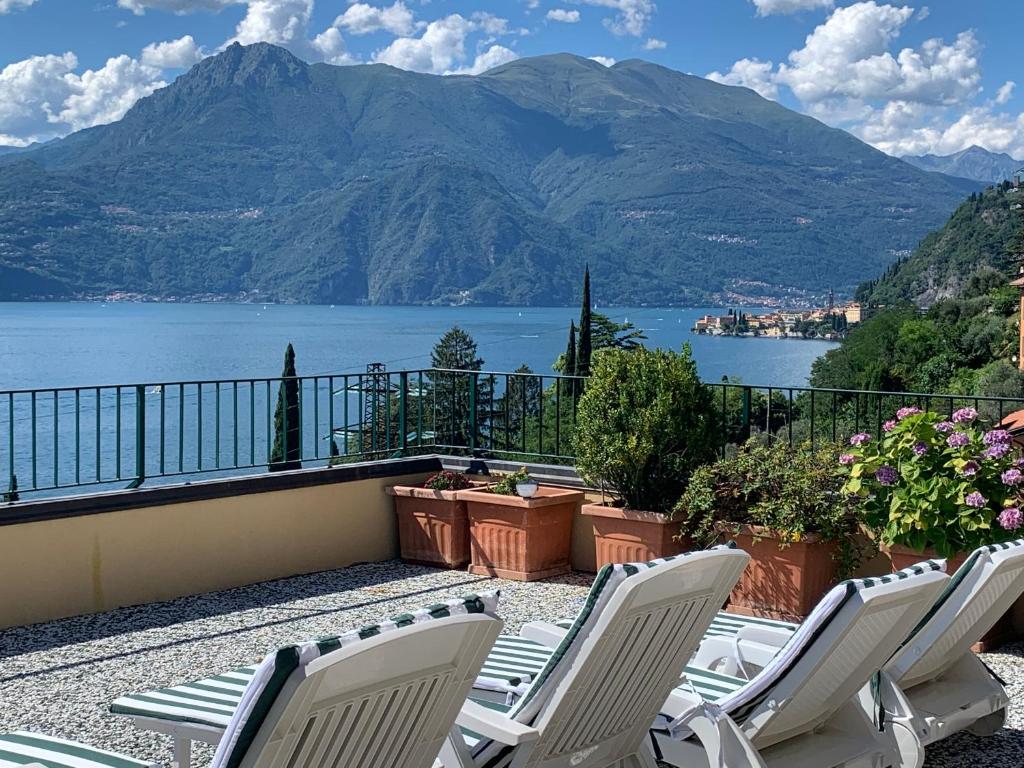 a balcony with chairs and a view of the water at Il terrazzo sul Lago in Varenna