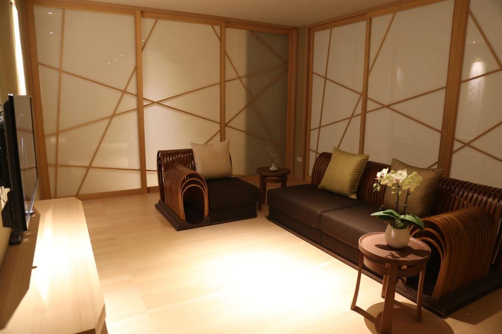 a living room with a couch and two chairs at Chiayi Maison de Chine Hotel in Chiayi City