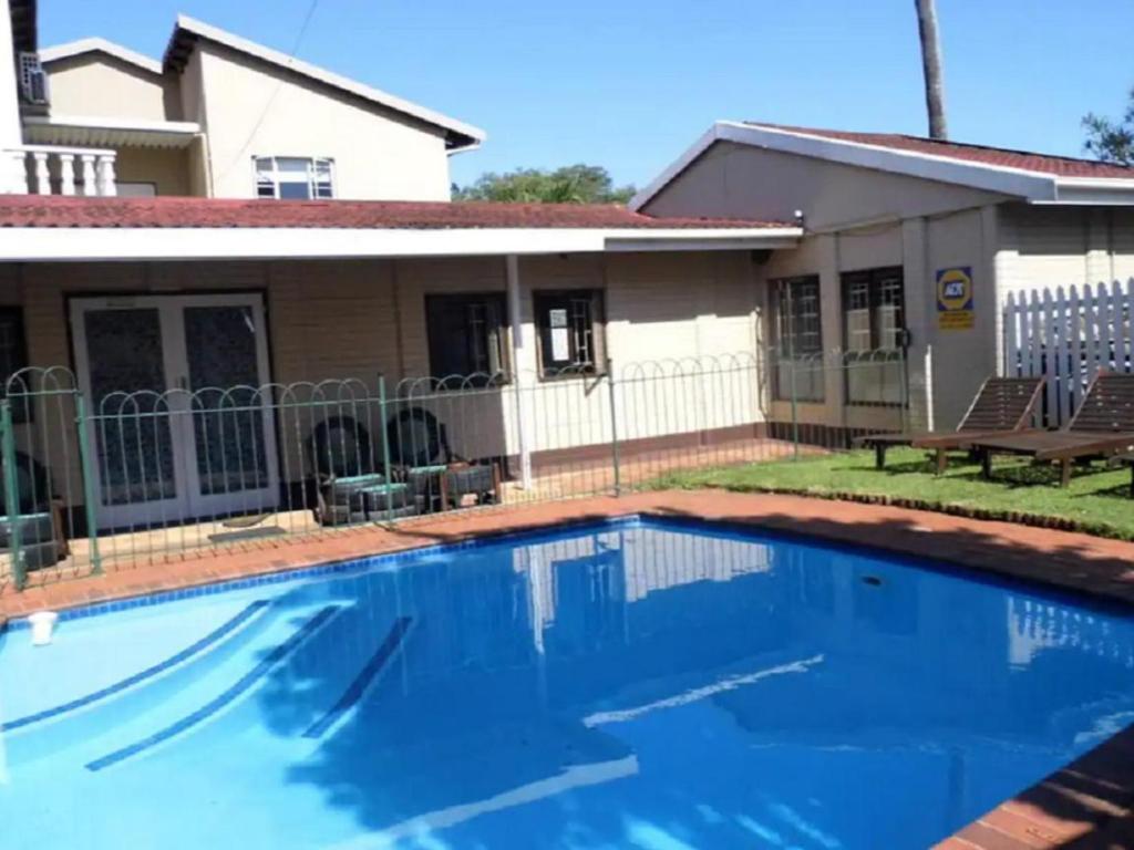 a swimming pool in front of a house at Bougainvillea BNB in Durban