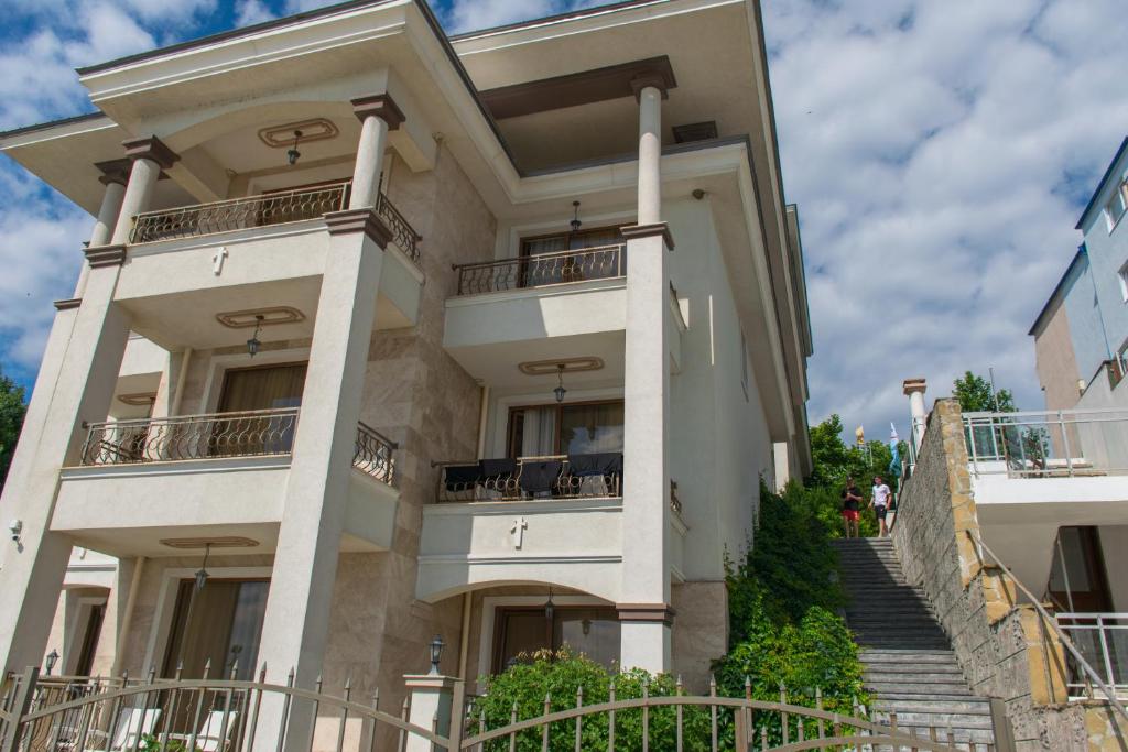 a large building with stairs in front of it at Paraiso Theopolis - All Inclusive in Obzor
