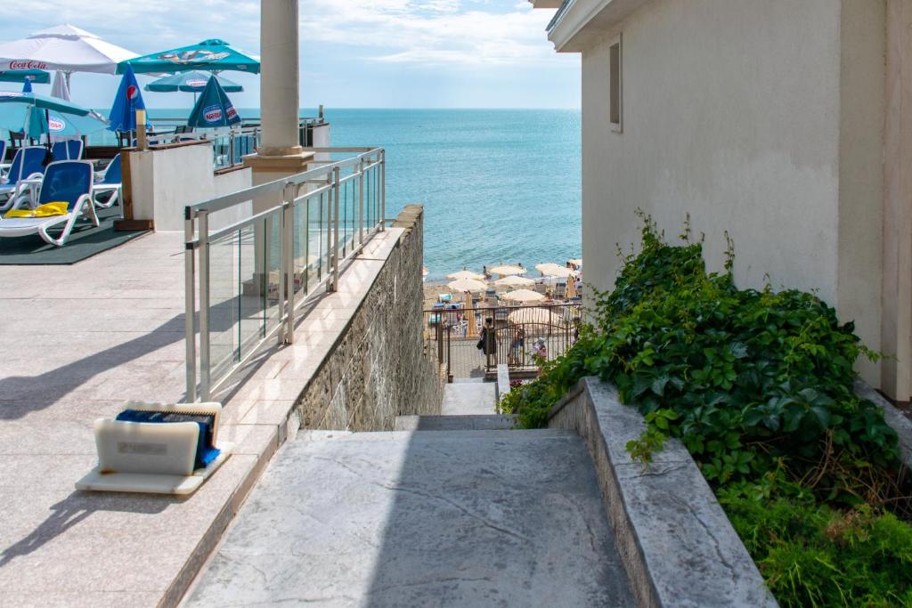 a stairway leading down to the ocean from a building at Paraiso Theopolis - All Inclusive in Obzor