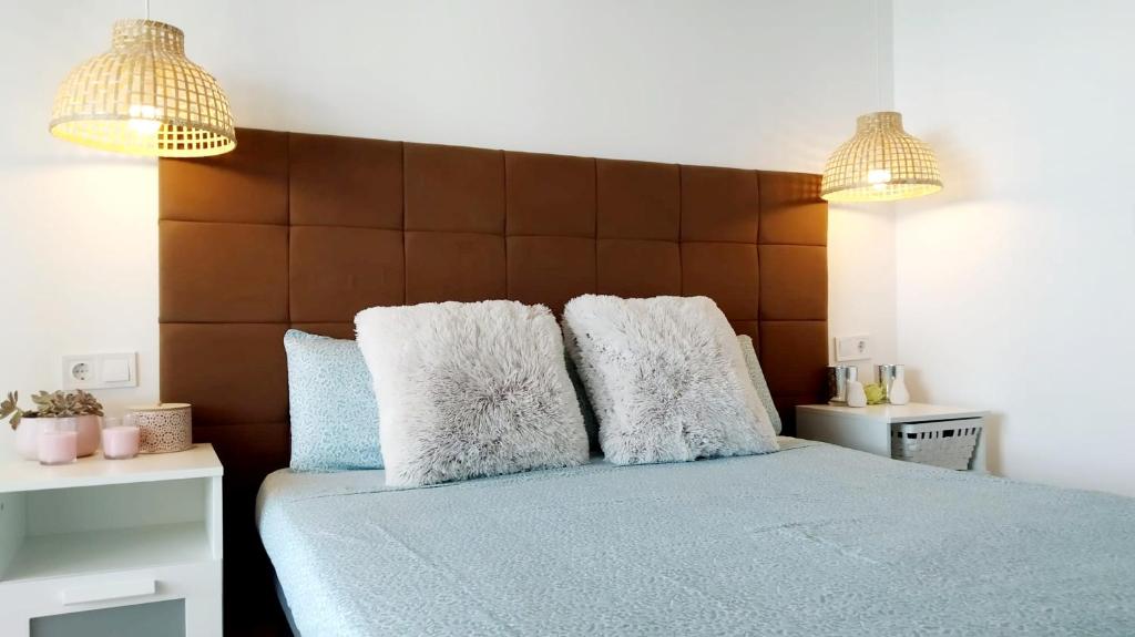 - une chambre avec un lit bleu et 2 oreillers dans l'établissement Adosado con fantásticas vistas al mar y piscina., à Peñíscola