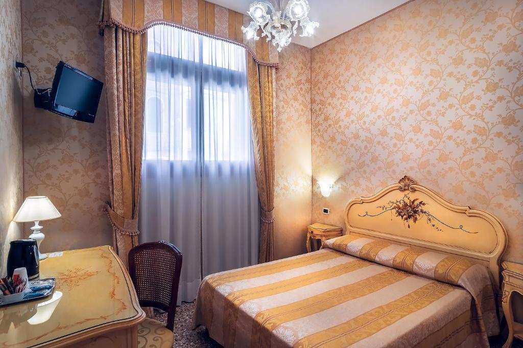 Postel nebo postele na pokoji v ubytování Hotel Al Malcanton