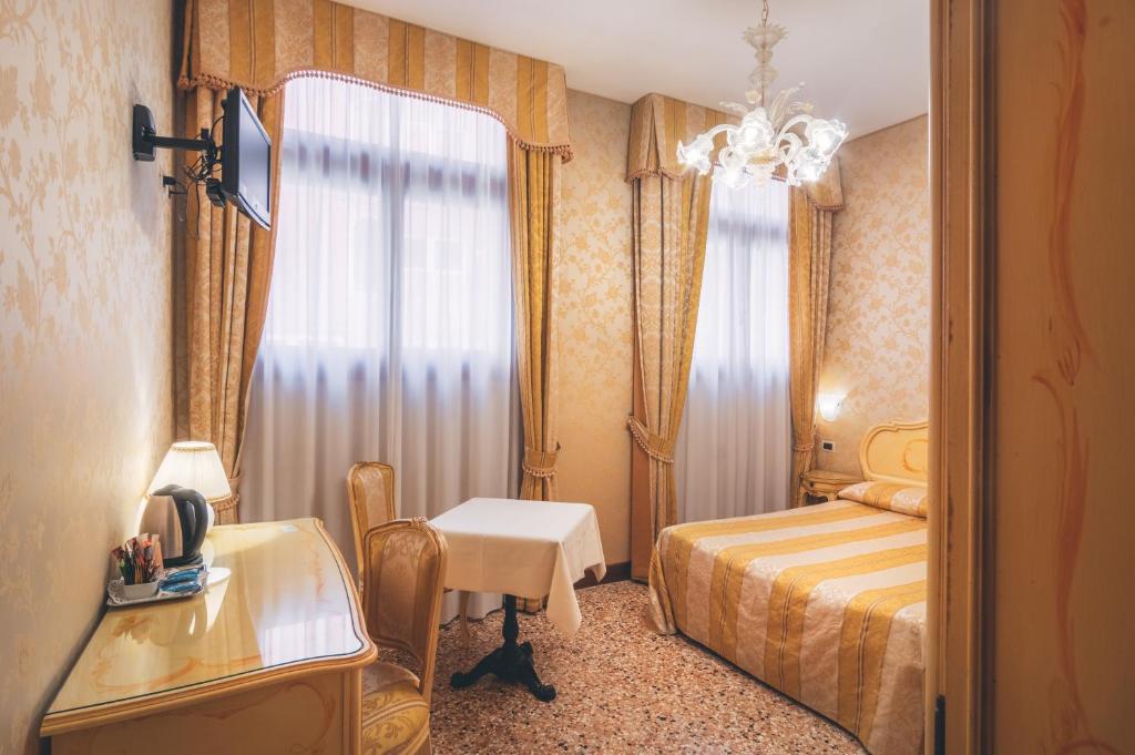 Postel nebo postele na pokoji v ubytování Hotel Al Malcanton