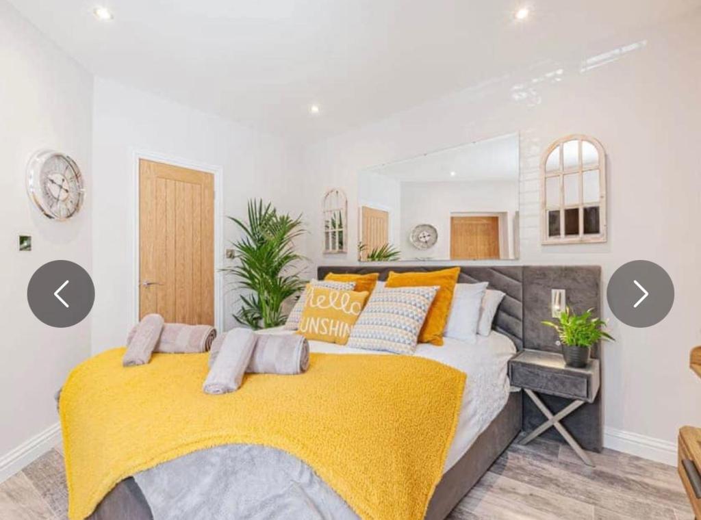 a bedroom with a large bed with a yellow blanket at The Bolthole in Margate