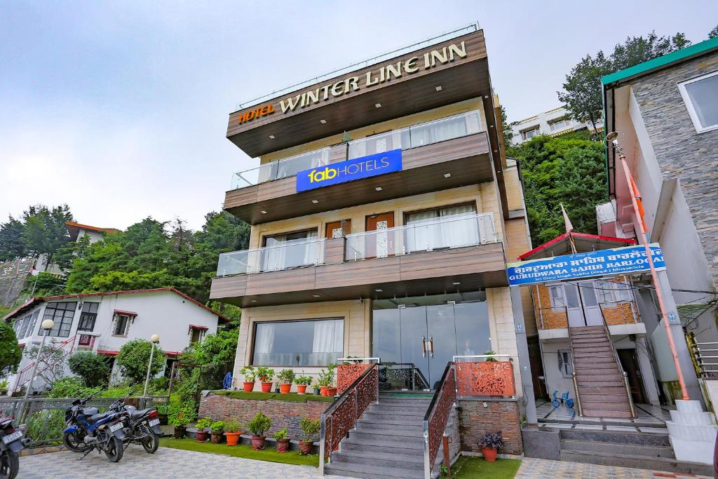 a building with a sign that reads iron winter living inn at FabHotel Winter Line Inn in Mussoorie