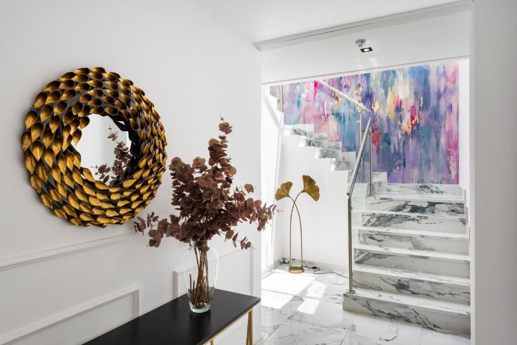 Quivir Apartamentos Deluxe Casa del Arco في أندوخار: مزهرية مع الزهور على طاولة في غرفة