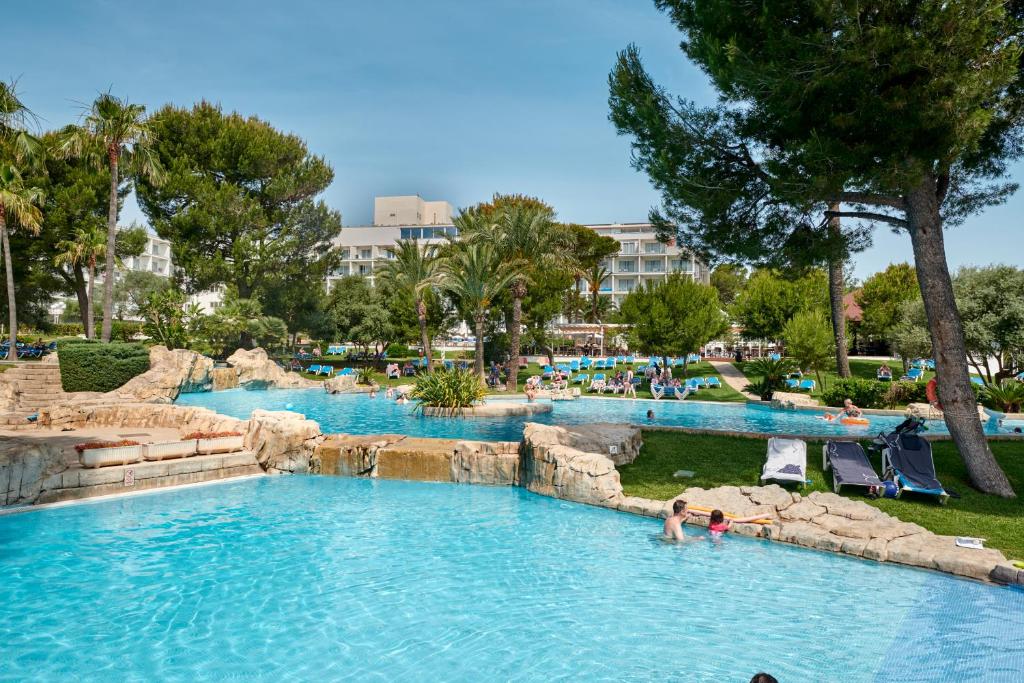 a pool at a resort with people swimming in it at Grupotel Gran Vista & Spa in Can Picafort