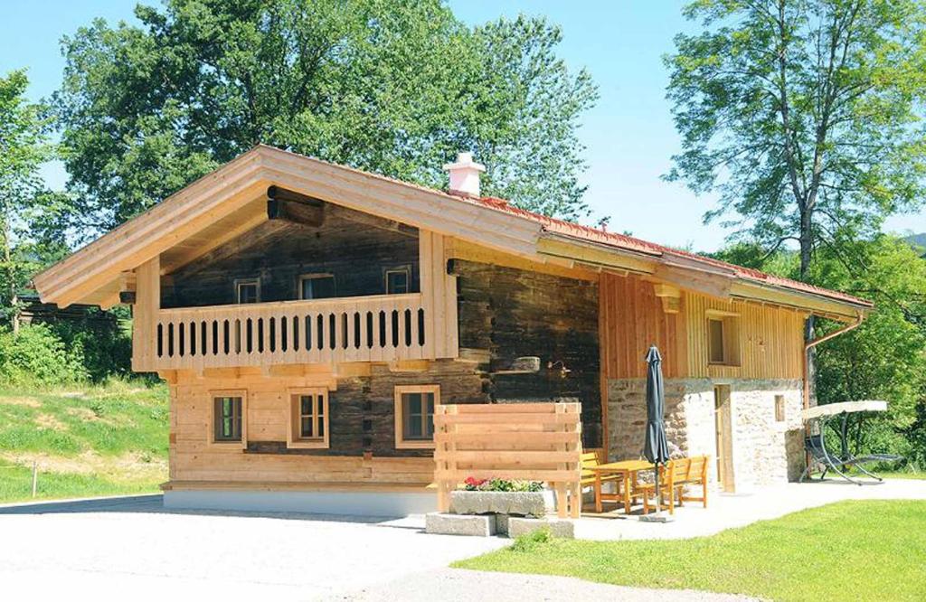 a small log cabin with a porch and a patio at Exenbacher Hof Traumbauernhaus s´Haisl in Arnbruck
