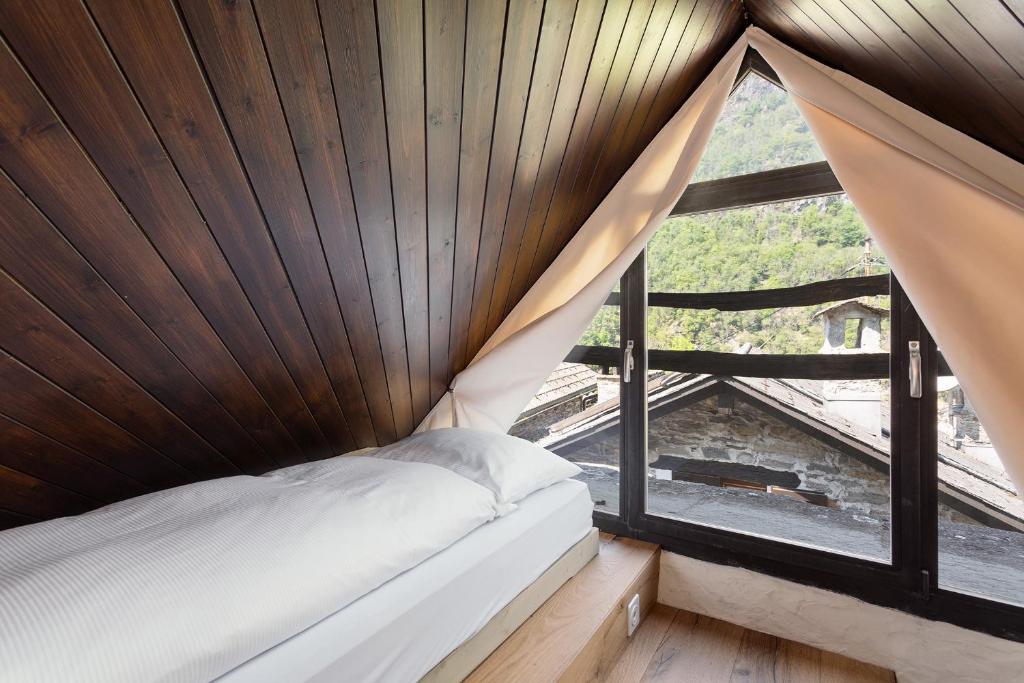 Postel nebo postele na pokoji v ubytování Rustici della Verzasca Ferien Wohnungen