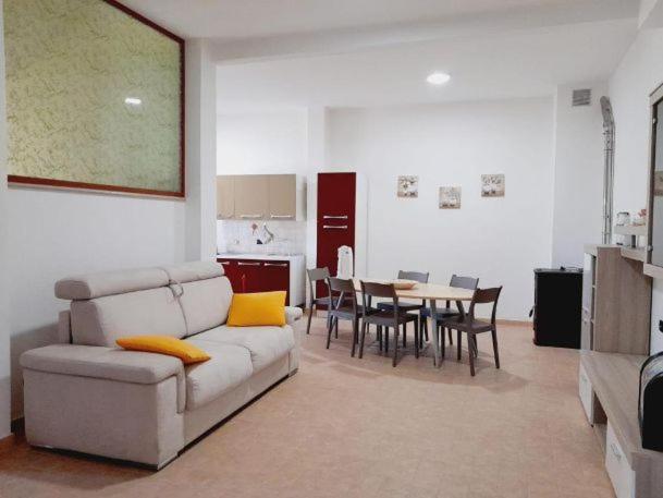 a living room with a couch and a table at Casa Vacanze Sunshine in Scanzano