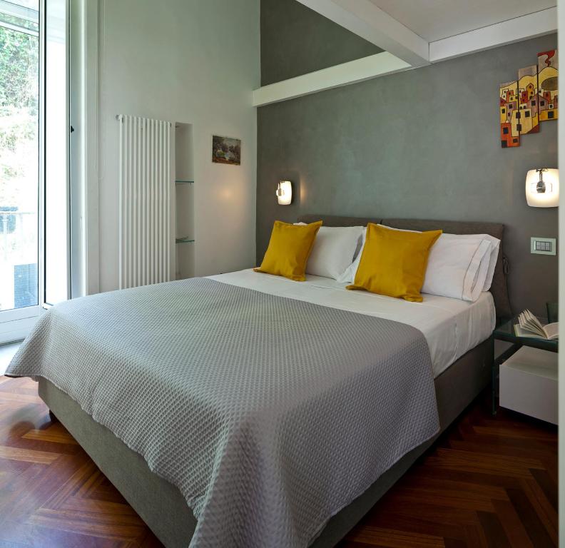 sypialnia z dużym łóżkiem z żółtymi poduszkami w obiekcie Elegant Apartment at Chiaia by Wonderful Italy w mieście Napoli
