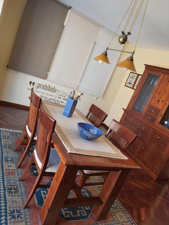 a wooden table with chairs and a bowl on it at JALEPA in Muxia