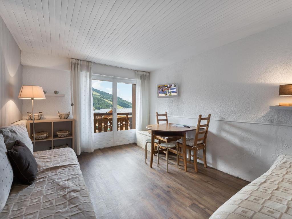a bedroom with a table and chairs and a window at Studio Courchevel 1650, 1 pièce, 3 personnes - FR-1-563-62 in Courchevel