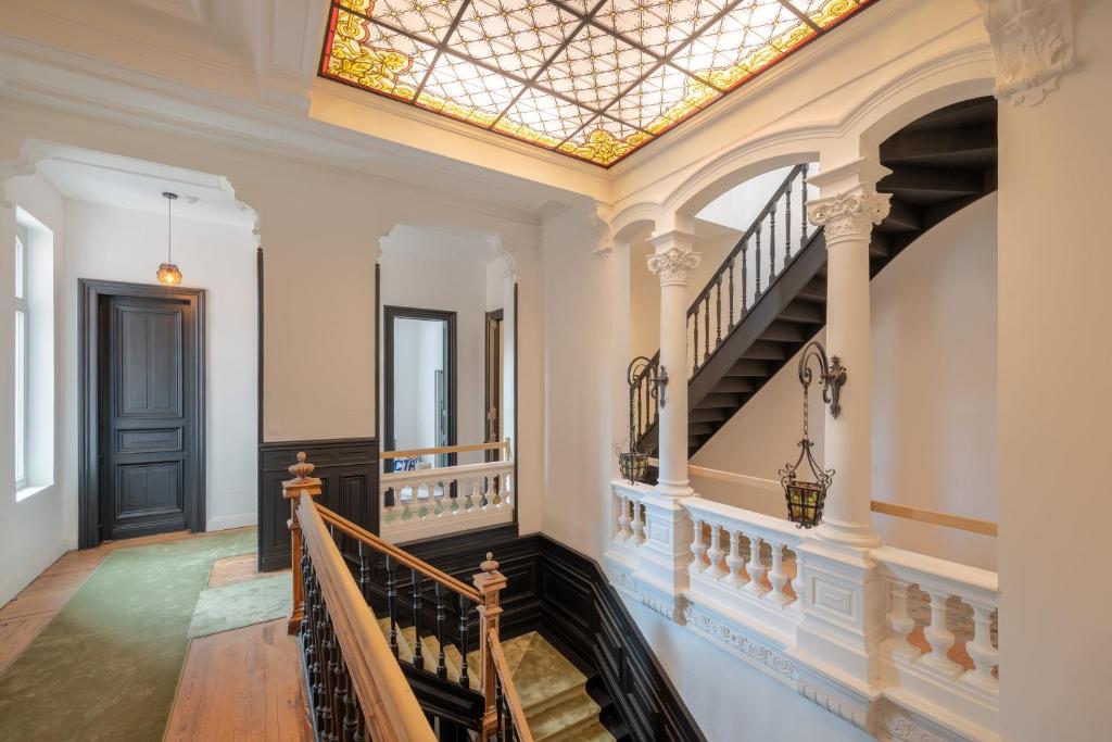 a skylight in the ceiling of a hallway with stairs at Maison Mimerel Colodge in Roubaix