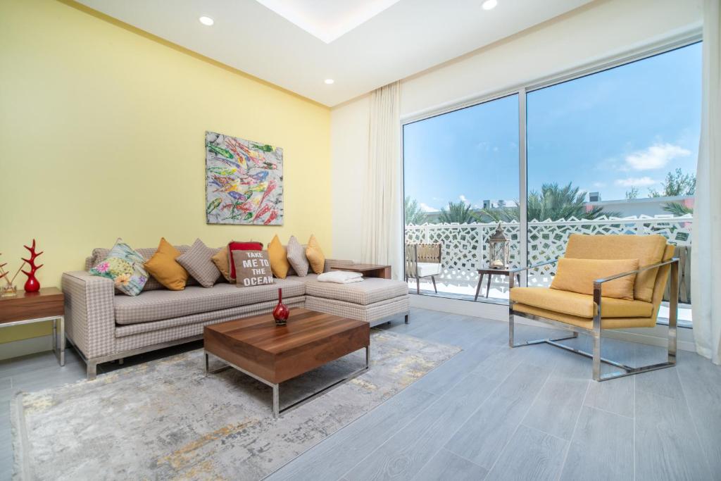 a living room with a couch and a table at Luxury 1 bed apartment near Seven Mile Beach at The Grove - Villa Pina Colada in Upper Land