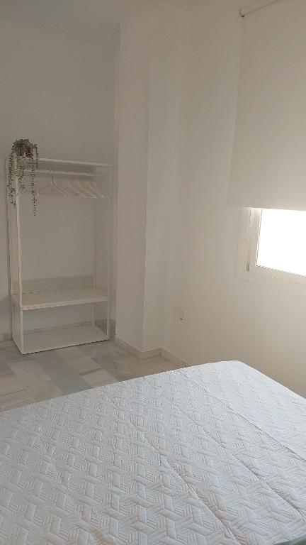 Posteľ alebo postele v izbe v ubytovaní Ático Vacacional Manzanilla