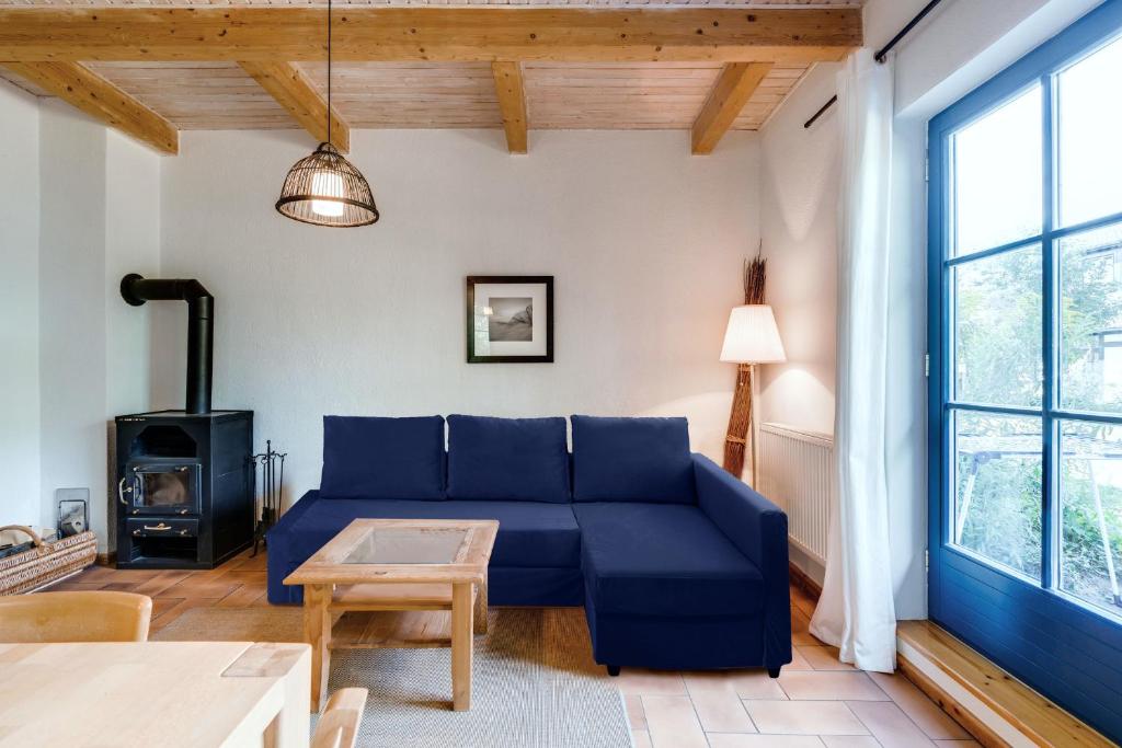 a living room with a blue couch and a stove at 4-Raum Apartment bis 8 Pers 43 in Rankwitz