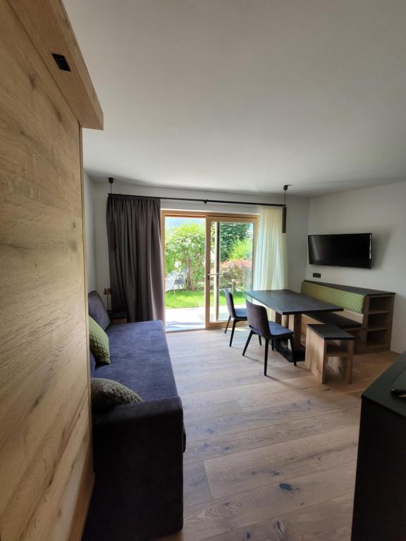 a living room with a couch and a table at Apartments Stlarida in Ortisei