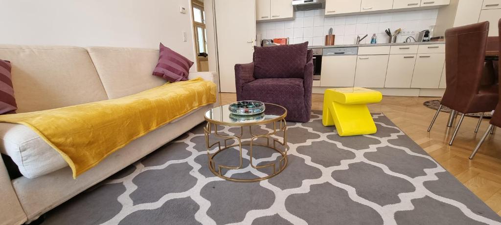 a living room with a couch and a table at Urban Serviced Apartments in Vienna