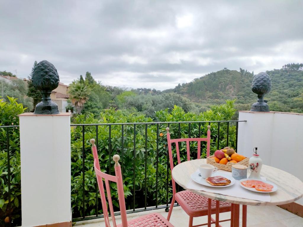 a table with a bowl of fruit on a balcony at Casa rural El Olivo in Aracena