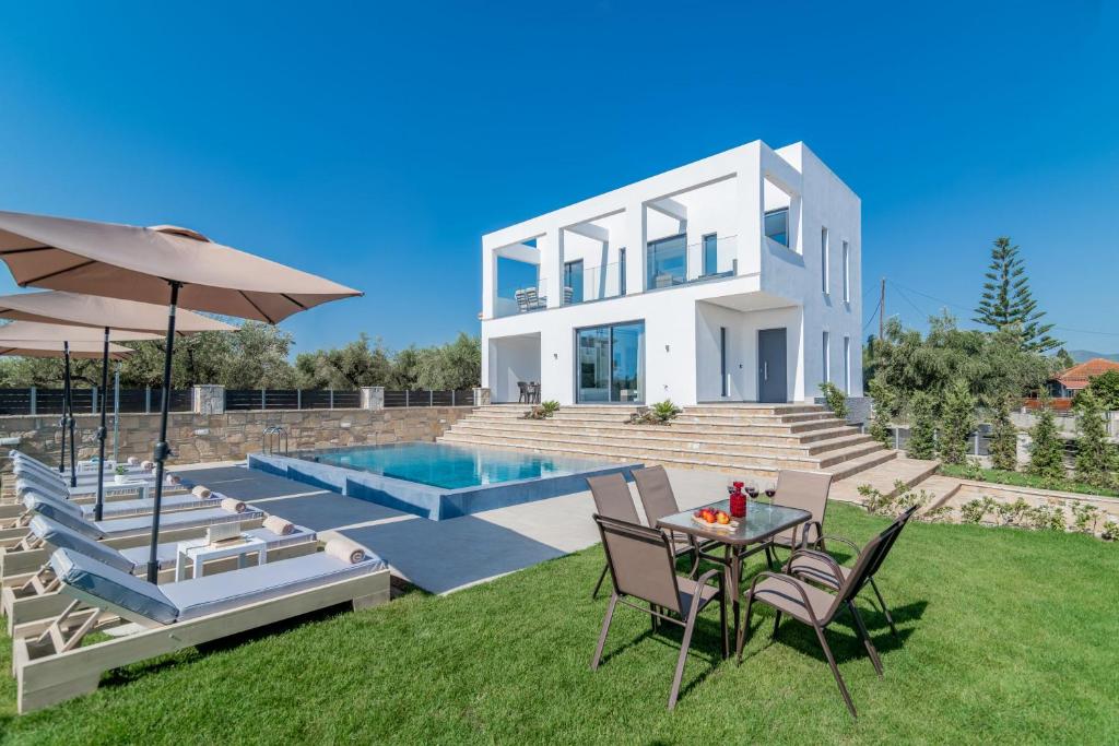 a villa with a swimming pool and a house at Boheme Villa in Zakynthos Town