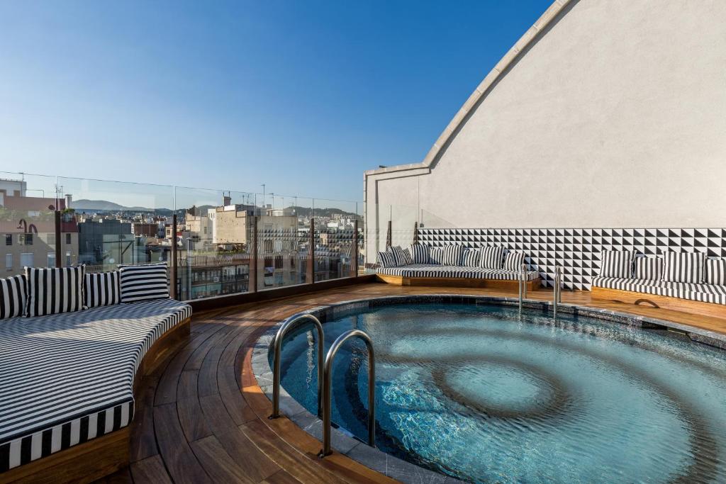 a swimming pool on the roof of a building at Room Mate Anna in Barcelona