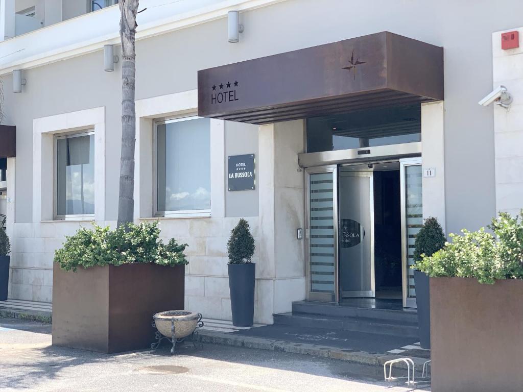 a hotel entrance with plants in front of it at Hotel La Bussola in Milazzo