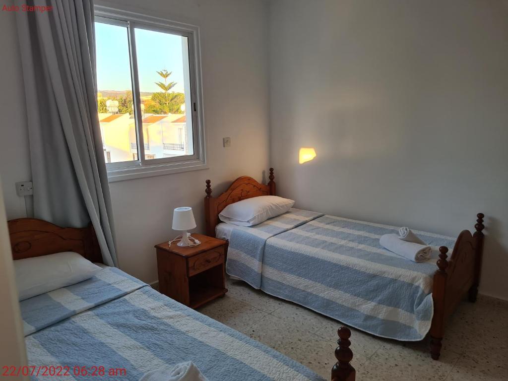 Postel nebo postele na pokoji v ubytování Latchi Area Apartments