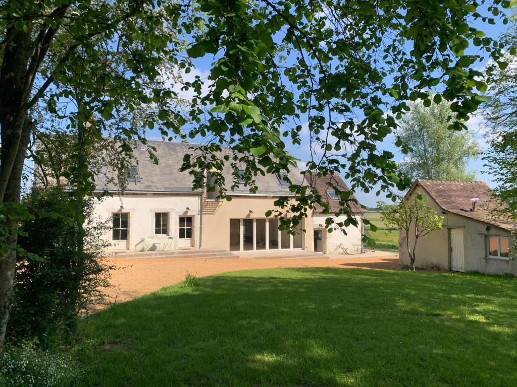 a large white house with a large yard at La Maison Vivante, chambres d'hotes au coeur du Perche in Les Étilleux