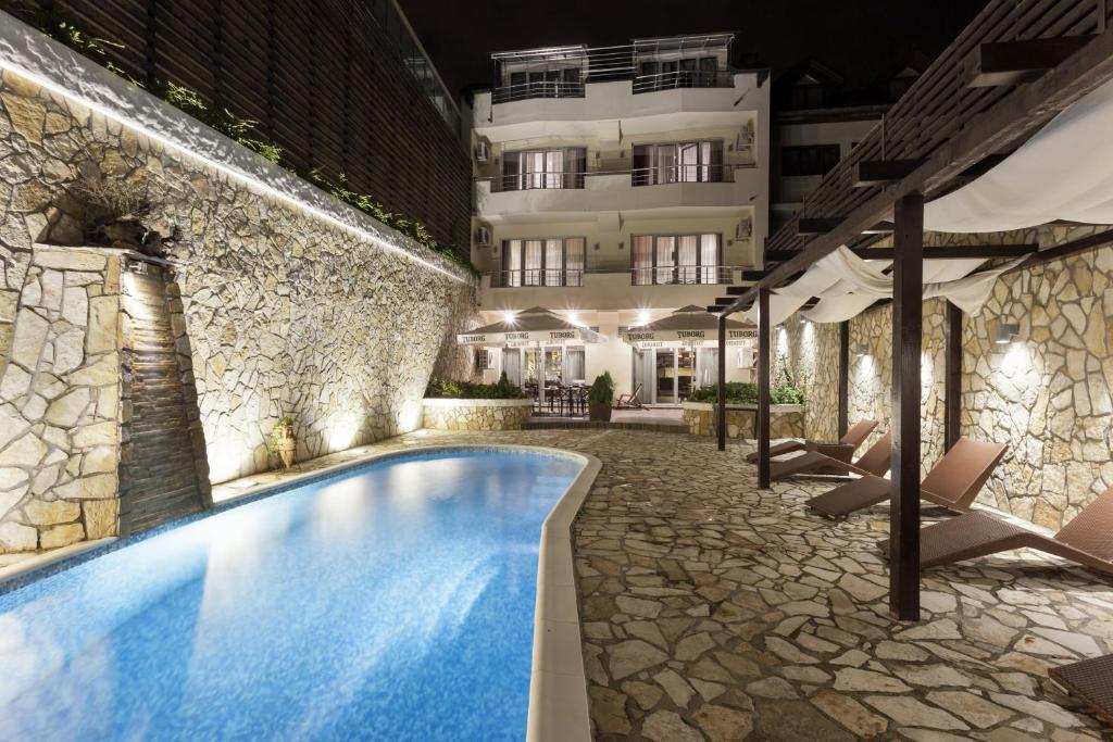 a hotel swimming pool in front of a building at Belgrade Boutique House in Belgrade