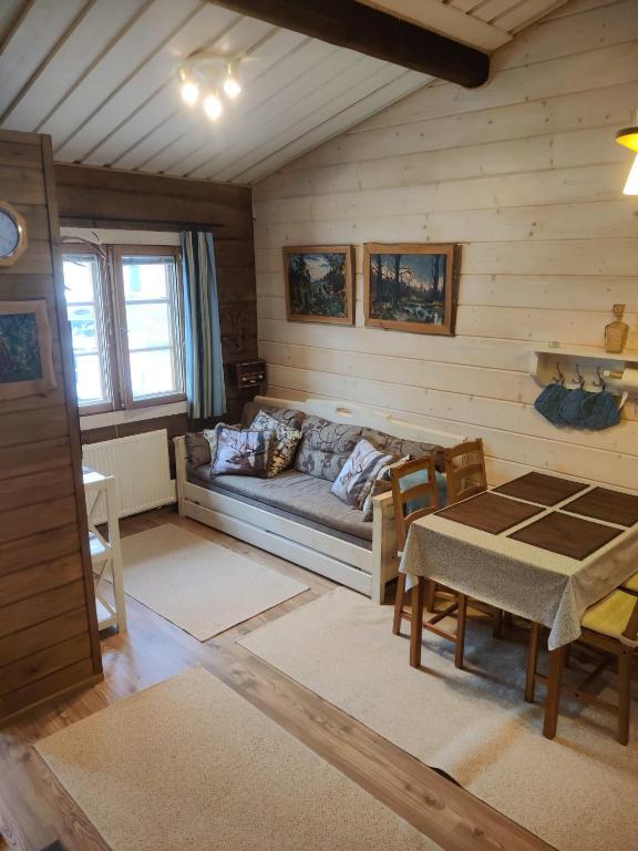 a living room with a couch and a table at Rukansyli 2 in Ruka