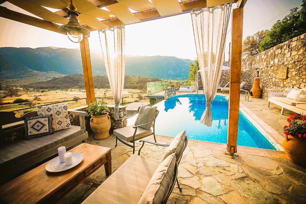 sala de estar con vistas a la piscina en Traditional Villa Askyfou, en Karés