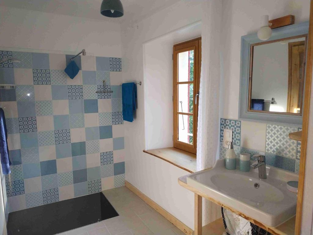 a bathroom with a sink and a mirror at -Moulin de Solaure- in Pont-de-Quart