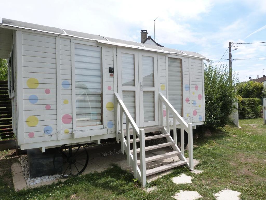 einem weißen Wohnwagen mit einer Treppe neben einem Haus in der Unterkunft CHEZ CLAUDINE ET PASCAL in Châlons-en-Champagne