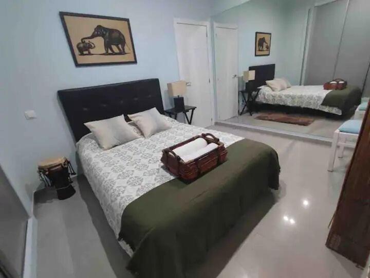 a bedroom with a bed with a bag on it at APARTAMENTO PRIVADO CERCA DE IFEMA y AEROPUERTO in Madrid