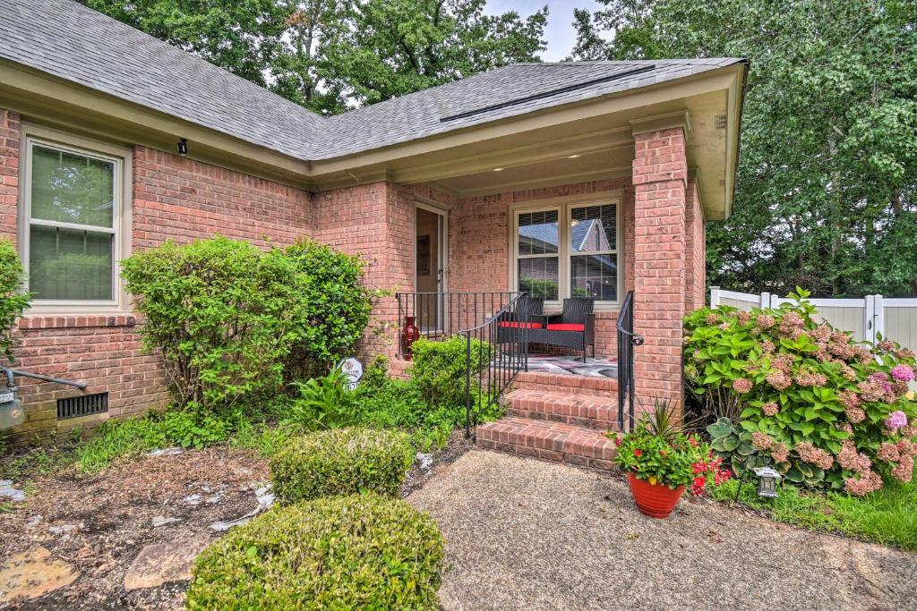 a brick house with a porch and stairs to the door at Bright Chesapeake Home Near Shopping and Dining in Chesapeake