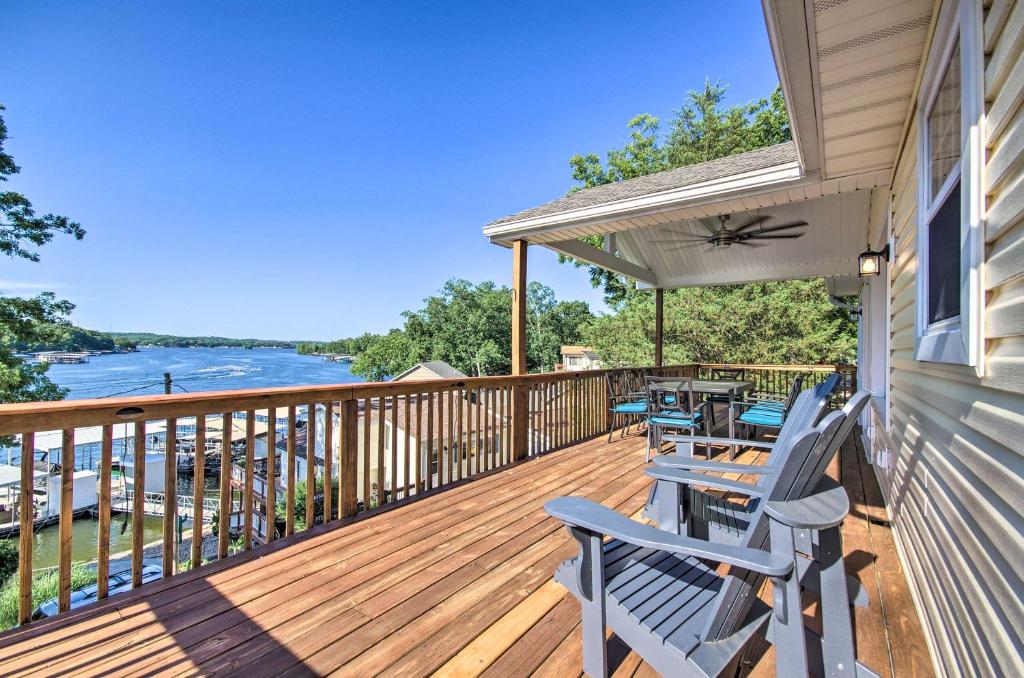 a deck with chairs and tables on a house at Sunrise Beach Home with Boat Dock on the Ozarks in Sunrise Beach