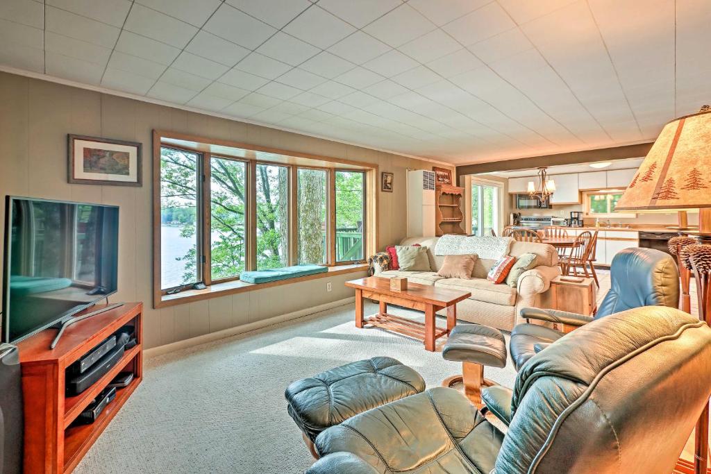 a living room with a couch and a tv at Le Roy Lakefront Retreat with Dock and Kayaks! in Le Roy