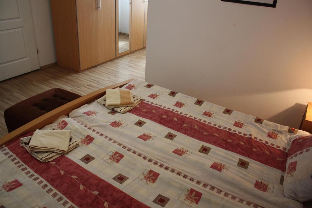 a bedroom with a bed with two towels on it at Willa Maxim in Lądek-Zdrój