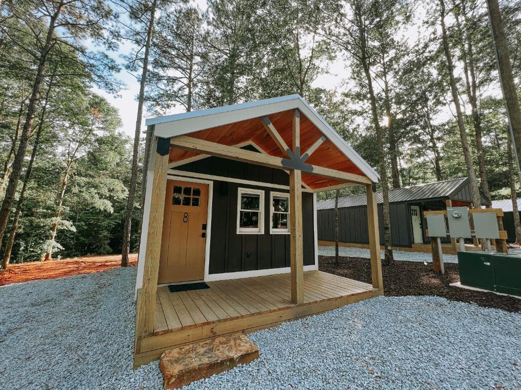 a small shed with a roof on top of it at Cabin #8 Studio With Kitchenette in Hartwell