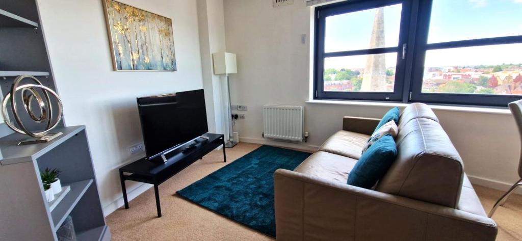 a living room with a couch and a large window at The Property Parlour in Reading