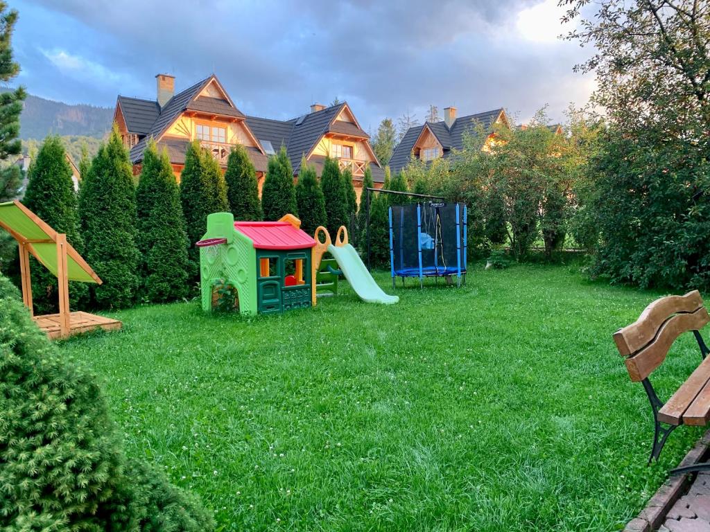 a yard with a playground and a play set at Pokoje Gościnne U Wioli in Zakopane