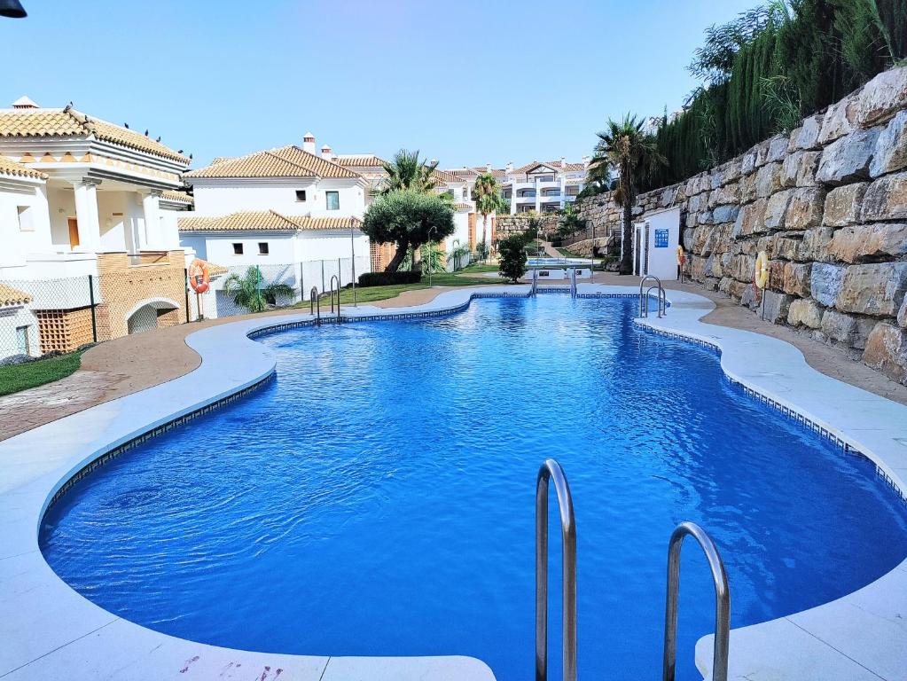 a large swimming pool with blue water at Albatros Golf View 2394 in Casares