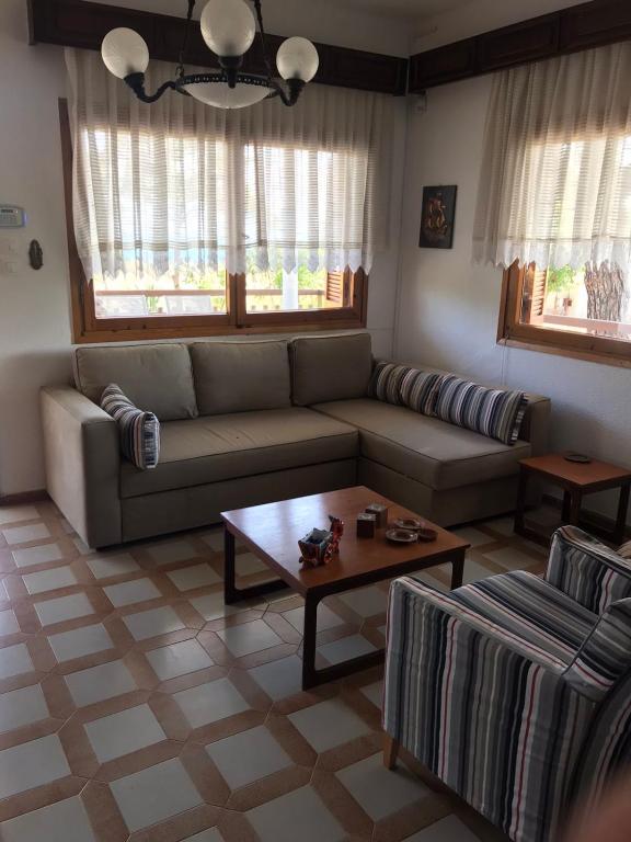 a living room with a couch and a coffee table at Daddy’s sea view house in Nea Irakleia