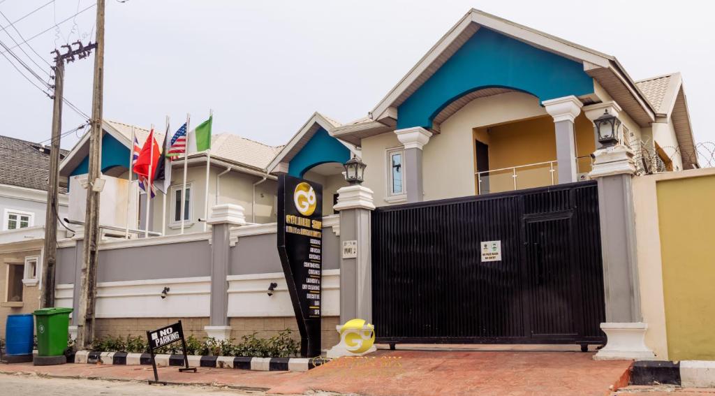 a house with a black gate in front of it at Golden Six Hotel and Restaurant in Lekki