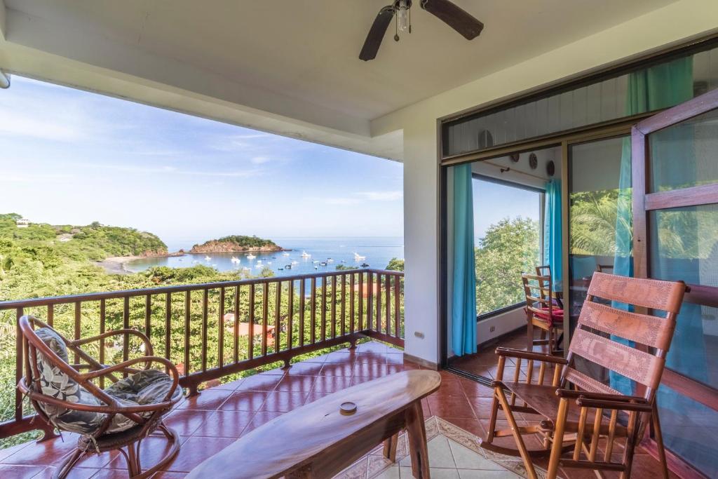 a balcony with chairs and a view of the ocean at Ocotal Beach Front Condo #38 in Ocotal