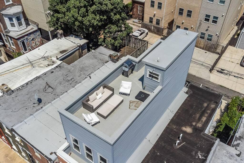 an overhead view of a blue house with couches at Trendy Fairmount Gem-5 star Location, Roof Deck, PARKING, GR8 for FAMILIES in Philadelphia