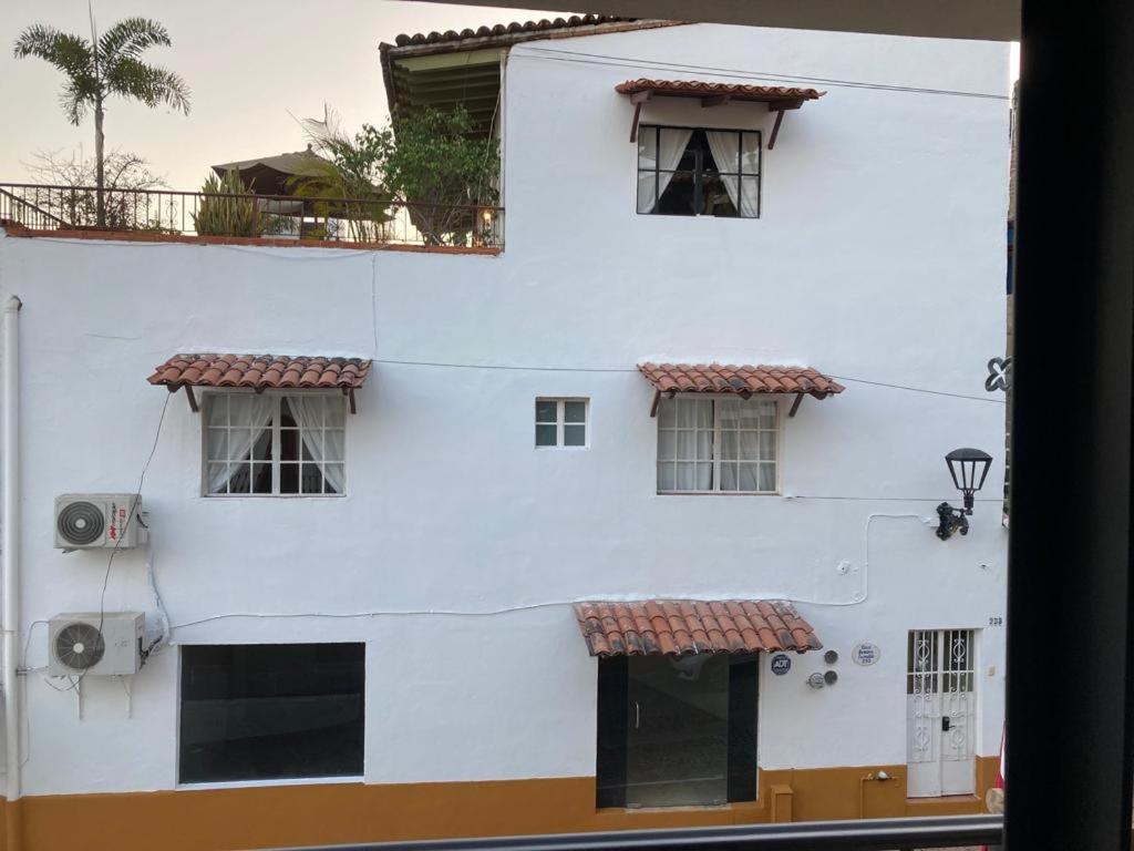 a white building with windows and a camera at Casa Romance Escondido in Puerto Vallarta